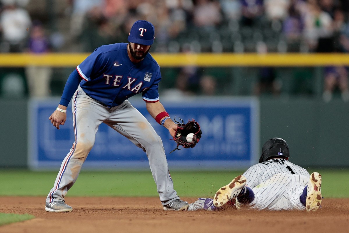 Jun 2, 2021; Denver, Colorado, USA; Colorado Rockies shortstop Garrett Hampson (1) steals second against Texas Rangers shortstop Isiah Kiner-Falefa (9) in the eighth inning at Coors Field.